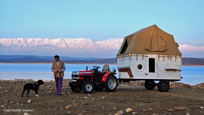 a single woman enjoying camping in wilderness at offbeat location with our caravan campervan to experience nomadic lifestyle for safe for solo girls in himachal pradesh india.