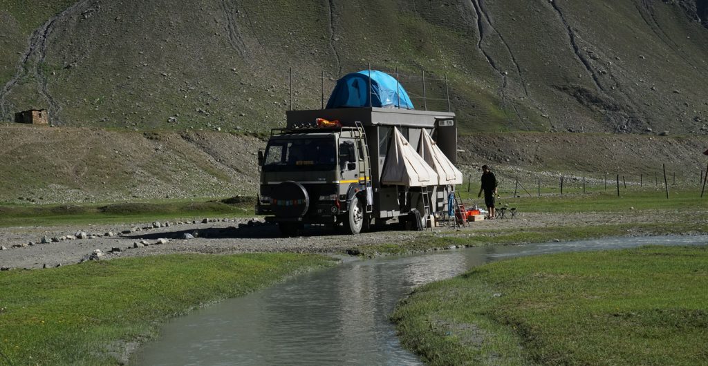 <img src="offbeat campervan caravan river camping leh ladakh.jpeg" alt="offbeat location overlanding riverside caravan campervan for photographers family, rejuvenate with nature, secluded quiet peaceful camp location, best veg food ladakh">