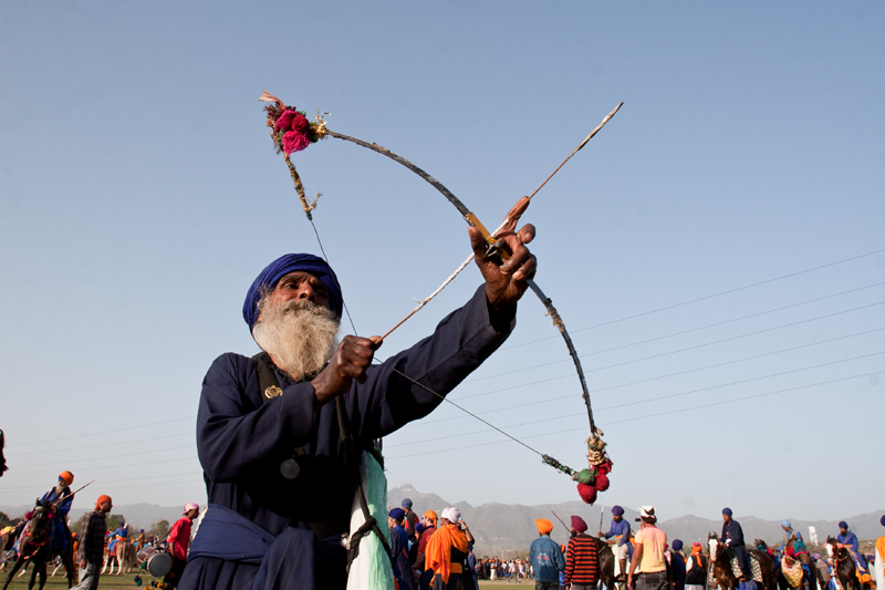 old nihang sikh diplaying archery skills.