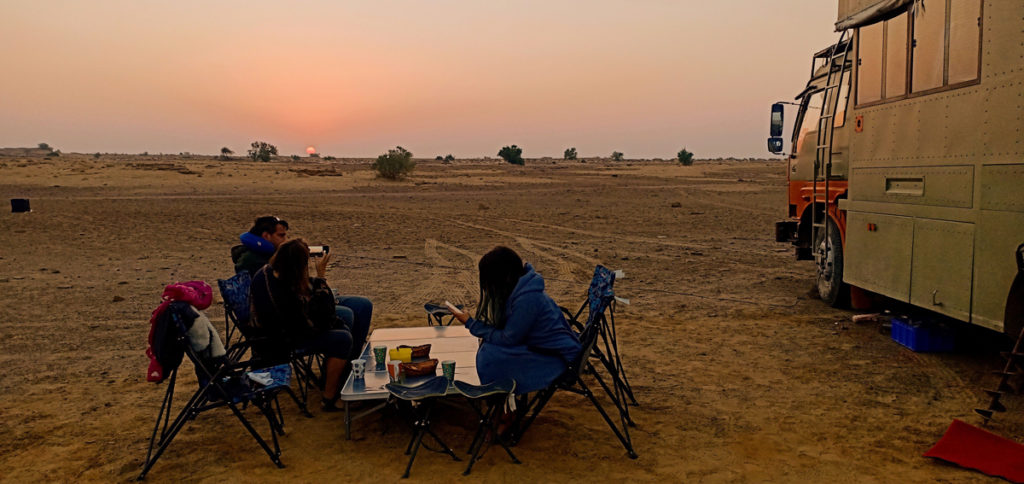 <img src="campervan caravan camp in wilderness sunrise.jpeg" alt="caravan campervan offbeat overlanding camp thar desert setting for unique night experience and private sunrise family holidays with comfort jaisalmer rajasthan india">