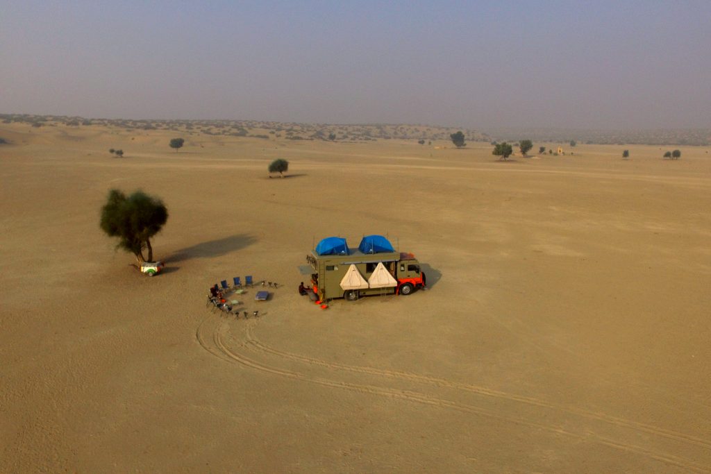 <img src="motorhome nomadic overlanding holidays.jpeg" alt="motorhome caravan offbeat secluded exclusive exotic vacation rural rajasthan camping exotic safe campervan vacation overlanding holiday onboard overland truck vanlife in wilderness for best for family holidays in village setting of barmer longewala jaisalmer rajasthan india">