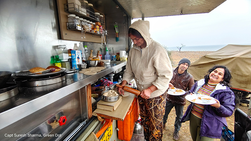 guest enjoying caravan motorhome campervan in wilderness himachal for offbeat outdoor nomadic overlanding camp holiday to relax unwind corona safe social distancing pong dam.