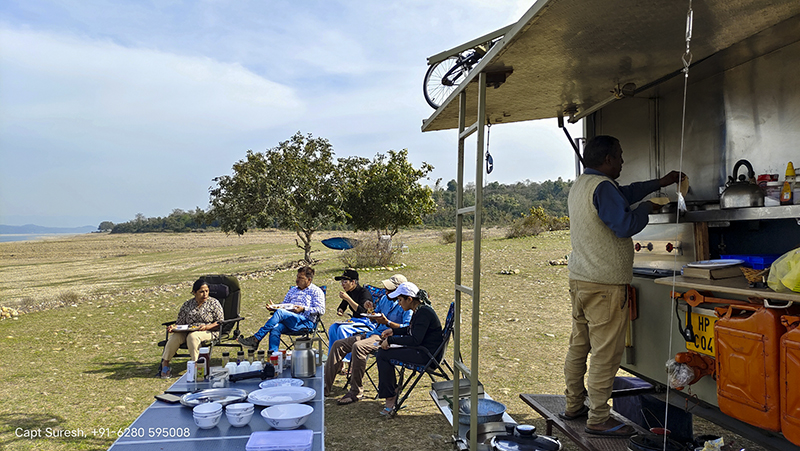 Family lunch time at our camp in wilderness with caravan motorhome campervan dharamshala palampur mcleodganj himachal for offbeat outdoor nomadic camp holiday corona safe with social distancing india.