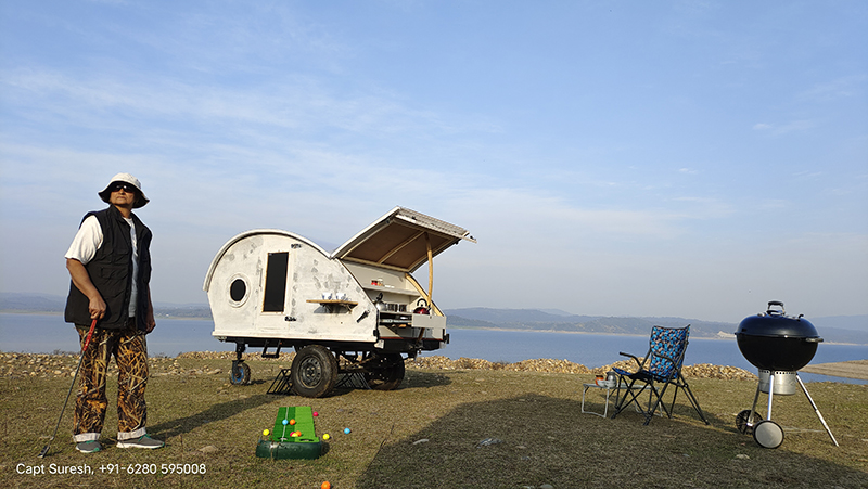 single senior citizen woman enjoying offbeat holidays and vacation at our mobile glamping with caravan motorhome campervan for old people and solo girls pong dam in himachal corona safe india.